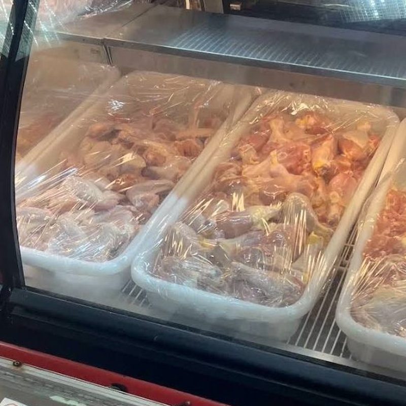 Fresh chicken and pork in trays at the Latino American Fresh meat counter